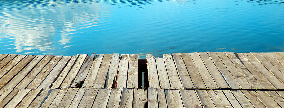 Deck-Rebuild A weathered deck along the water