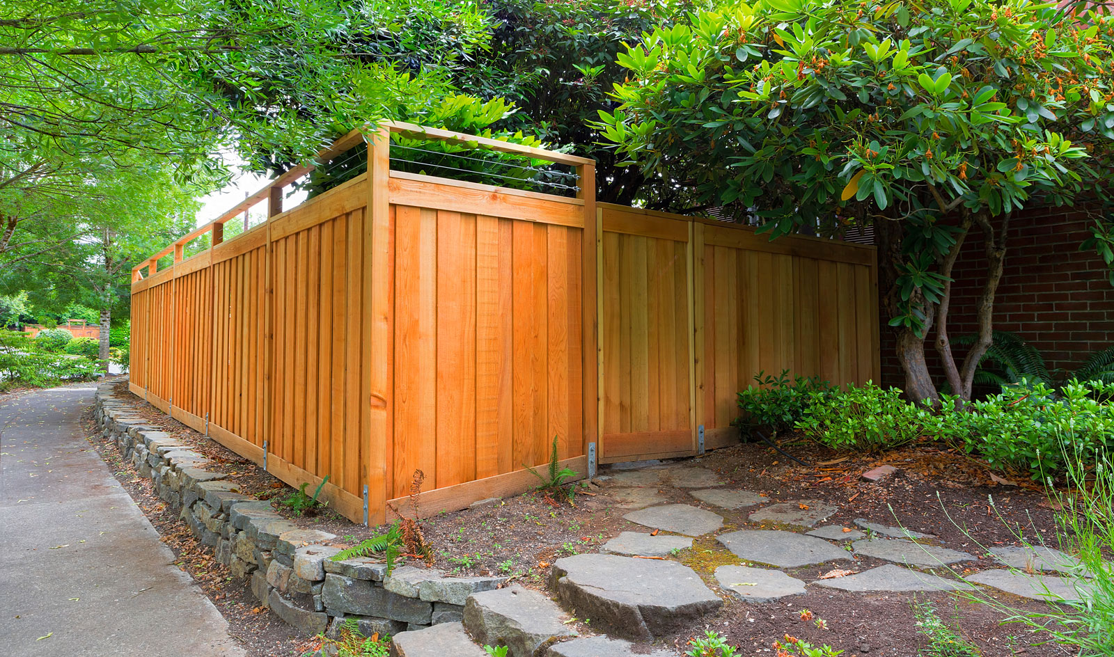 Fencing made from Red Cedar wood surrounded by gardens